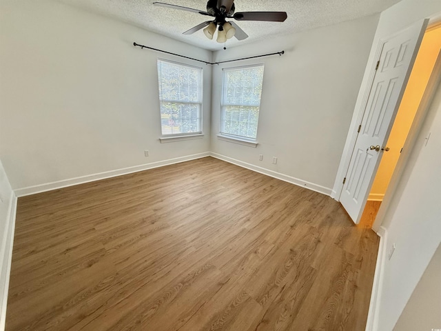 4273 Santolina Way Unit E, Murrells Inlet, SC 29576 - spare room with a ceiling fan, a textured ceiling, wood finished floors, and baseboards