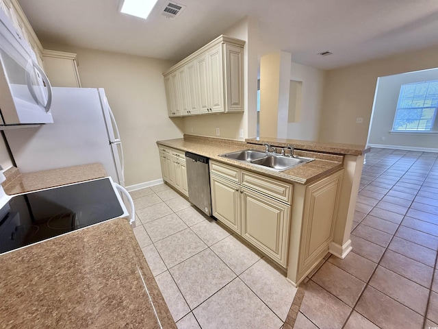 4273 Santolina Way Unit E, Murrells Inlet, SC 29576 - kitchen with white appliances, cream cabinets, light tile patterned flooring, a sink, and baseboards