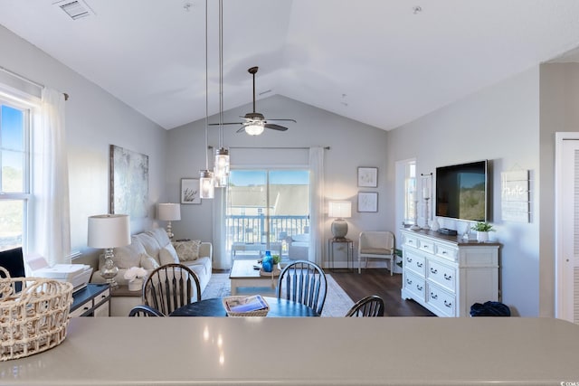 dining space featuring visible vents, a healthy amount of sunlight, ceiling fan, and vaulted ceiling