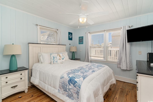 bedroom featuring ceiling fan, ornamental molding, wood ceiling, and hardwood / wood-style floors