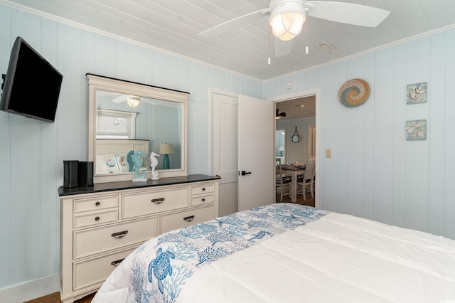 bedroom with ceiling fan and ornamental molding