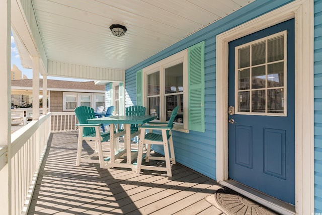 wooden terrace featuring covered porch