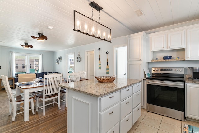 kitchen with ceiling fan, a center island, pendant lighting, stainless steel electric range oven, and white cabinets