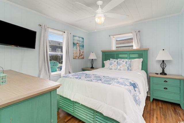 bedroom with ceiling fan, multiple windows, dark hardwood / wood-style floors, and ornamental molding