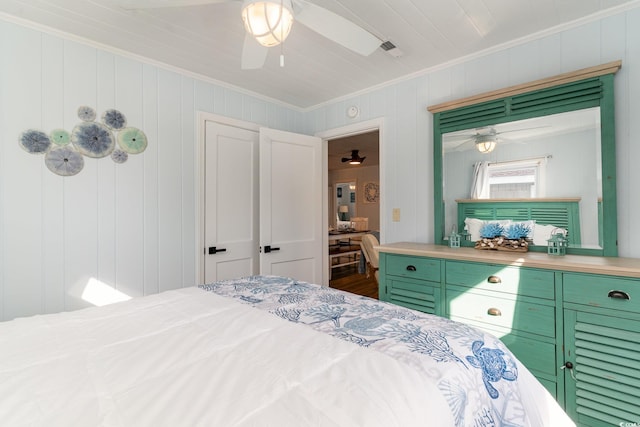 bedroom with ceiling fan and crown molding