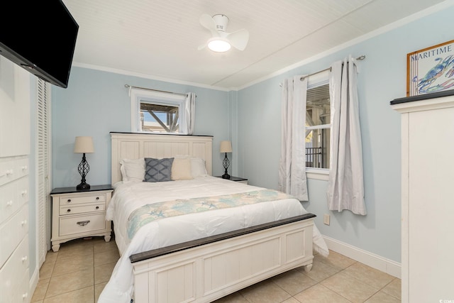 tiled bedroom with ceiling fan and ornamental molding