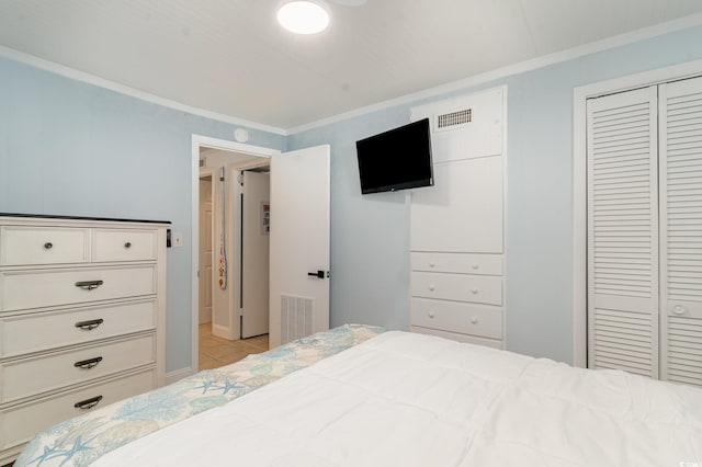 bedroom featuring a closet and crown molding