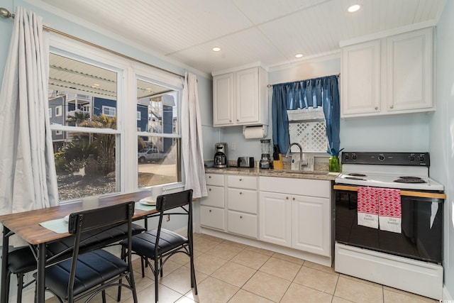 kitchen featuring white electric range, crown molding, white cabinetry, and sink