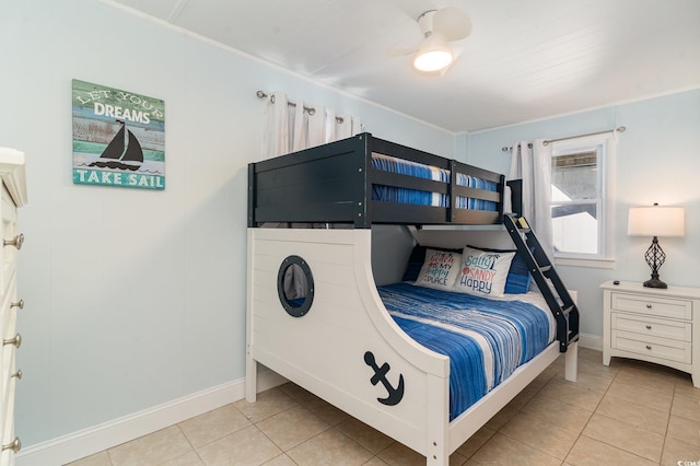 bedroom featuring ceiling fan, light tile patterned floors, and crown molding