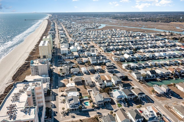 birds eye view of property with a water view and a view of the beach