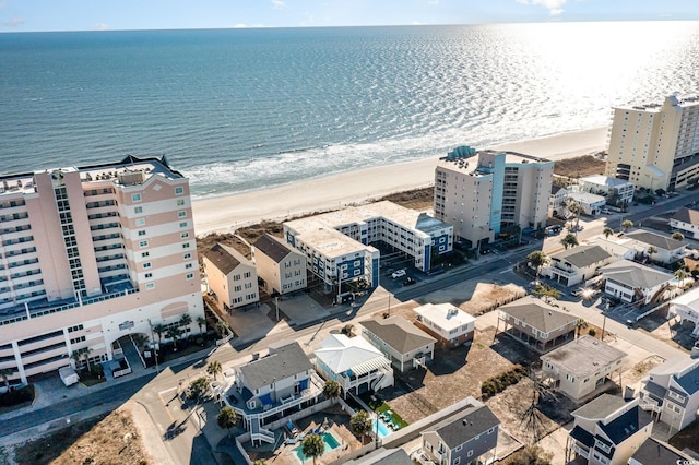 drone / aerial view with a beach view and a water view