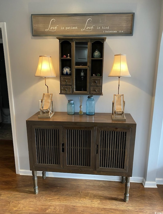 bar with wood-type flooring