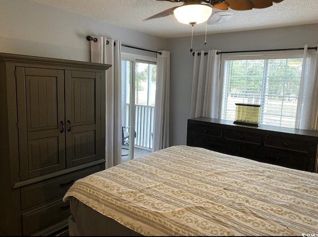 bedroom with ceiling fan, a textured ceiling, and access to outside