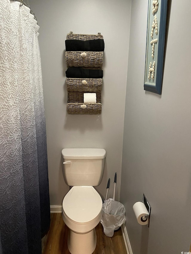 bathroom featuring hardwood / wood-style floors and toilet