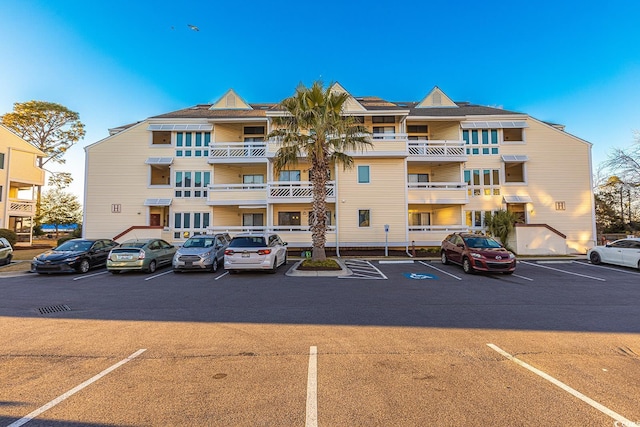 view of building exterior with uncovered parking