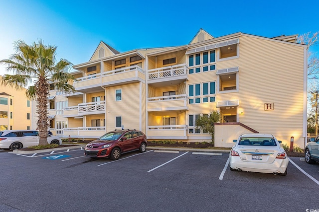 view of building exterior featuring uncovered parking