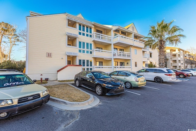 view of building exterior featuring uncovered parking