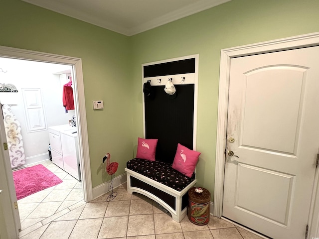 mudroom with light tile patterned flooring, separate washer and dryer, and ornamental molding