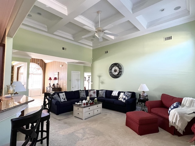 living room featuring light carpet, ceiling fan, ornamental molding, coffered ceiling, and beamed ceiling