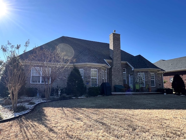 rear view of property featuring a yard