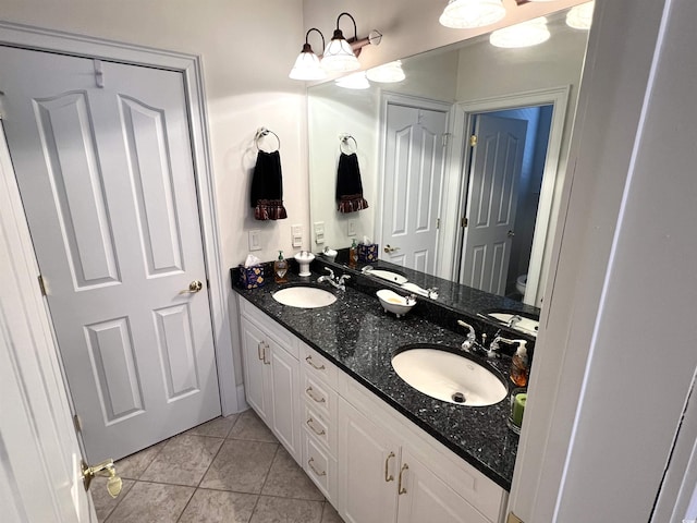 bathroom featuring toilet, vanity, and tile patterned flooring