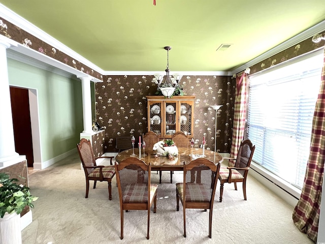 carpeted dining room featuring crown molding, a baseboard radiator, and decorative columns