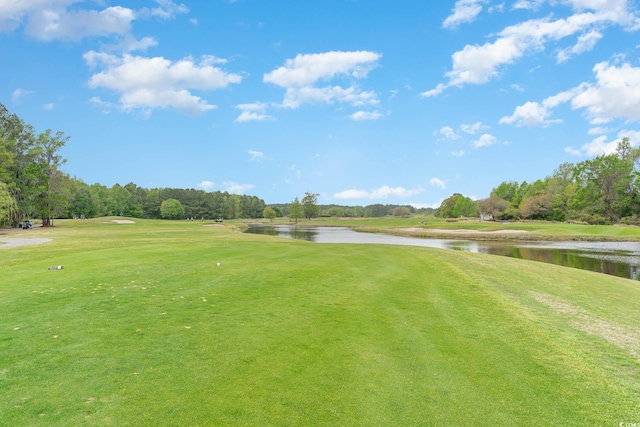 surrounding community featuring a yard and a water view