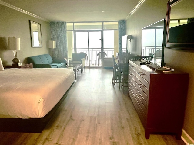 bedroom with light hardwood / wood-style flooring and crown molding