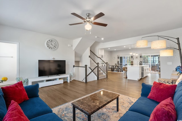 living area with light wood-type flooring, stairway, a ceiling fan, and recessed lighting