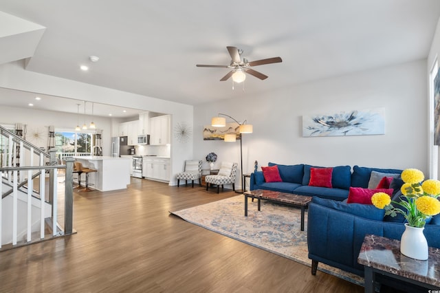 living room featuring stairs, ceiling fan, dark wood-type flooring, and recessed lighting