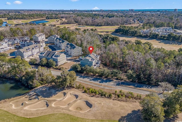 birds eye view of property featuring view of golf course and a water view