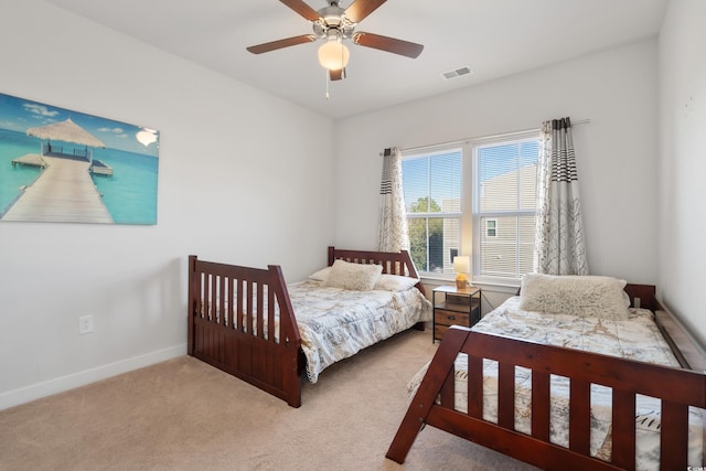 bedroom featuring a ceiling fan, carpet flooring, visible vents, and baseboards