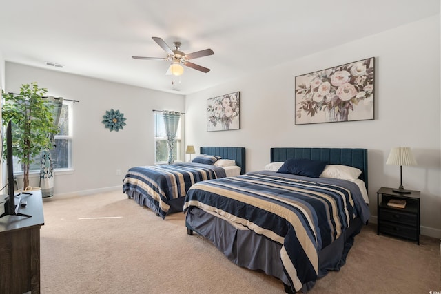 carpeted bedroom with ceiling fan, visible vents, and baseboards