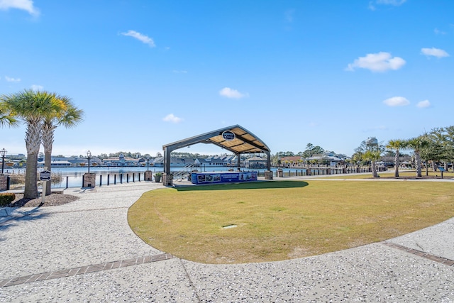 view of home's community featuring a gazebo, a lawn, and a water view