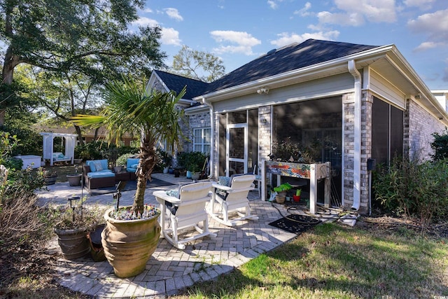 view of patio / terrace featuring a sunroom