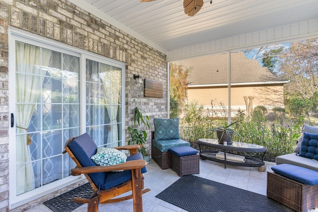 sunroom featuring ceiling fan