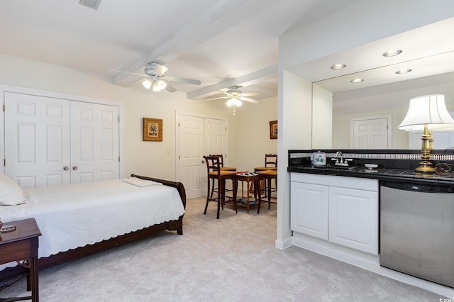 bedroom with beam ceiling, light colored carpet, ceiling fan, and sink