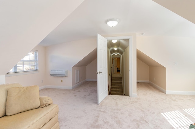 additional living space with vaulted ceiling, light colored carpet, and a wall mounted air conditioner