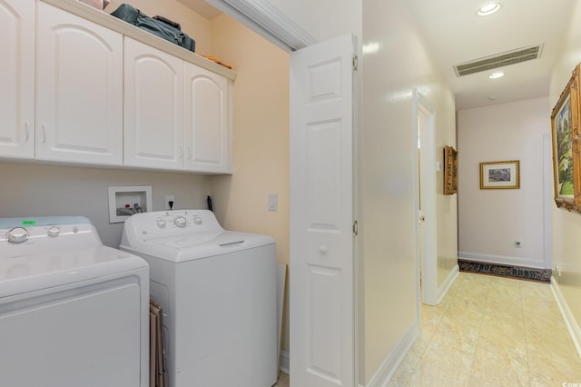 washroom with independent washer and dryer and cabinets