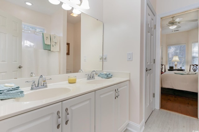 bathroom with ceiling fan, wood-type flooring, and vanity