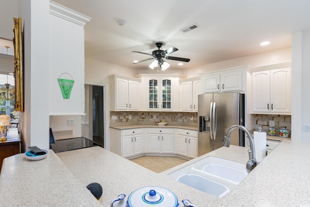 kitchen with white cabinetry, tasteful backsplash, sink, stainless steel fridge with ice dispenser, and ceiling fan