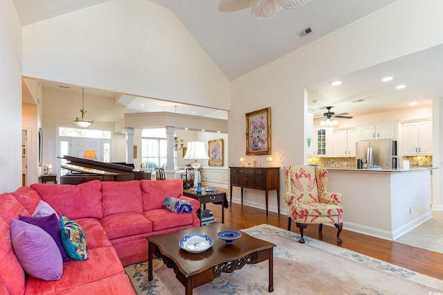 living room with high vaulted ceiling, light hardwood / wood-style flooring, and ceiling fan