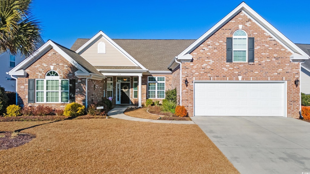 front of property featuring a garage and a front yard