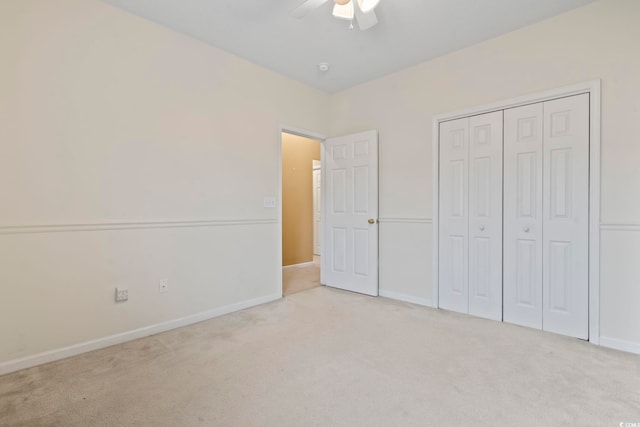 unfurnished bedroom with carpet floors, ceiling fan, baseboards, and a closet