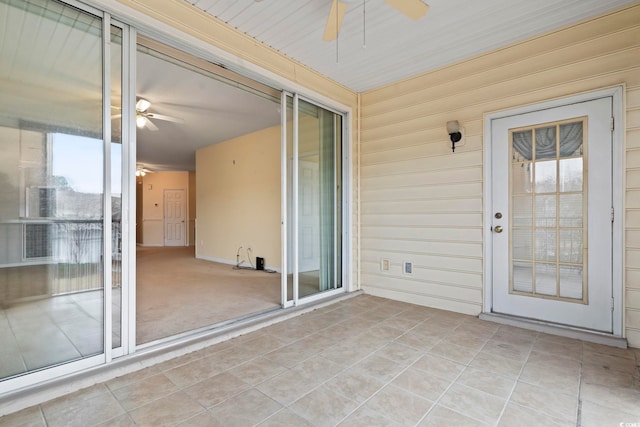 unfurnished sunroom with plenty of natural light and ceiling fan