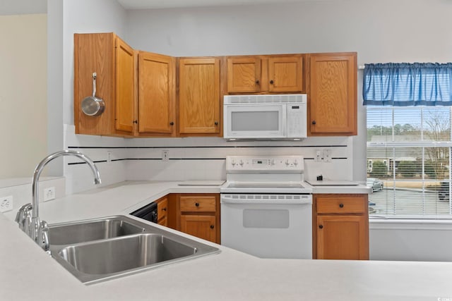 kitchen featuring tasteful backsplash, light countertops, brown cabinetry, a sink, and white appliances