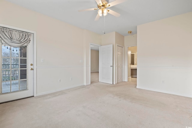 empty room featuring ceiling fan, carpet floors, and baseboards