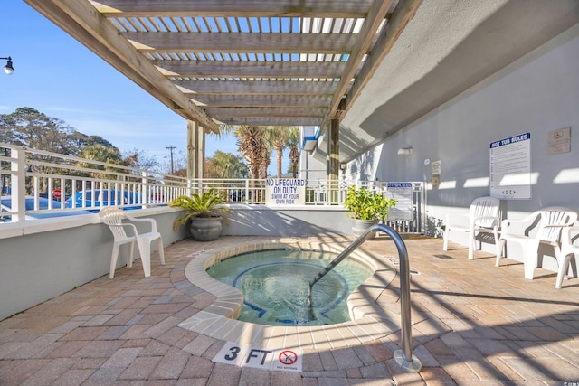 view of pool featuring a hot tub, a patio, and a pergola