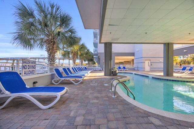 view of swimming pool with a patio area