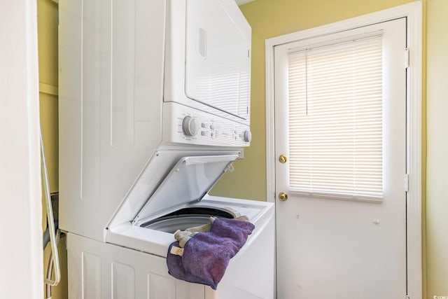 clothes washing area with stacked washer and dryer